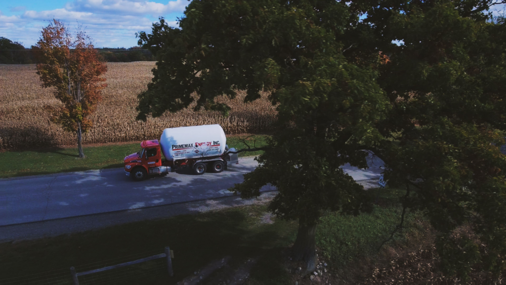 A Primemax Energy Propane Truck driving on a rural road.